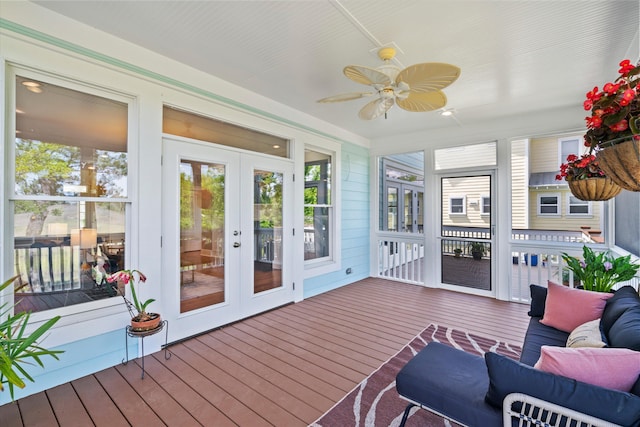 sunroom / solarium featuring french doors, ceiling fan, and plenty of natural light