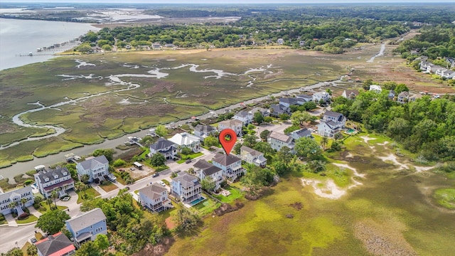 aerial view of property's location with a nearby body of water and nearby suburban area