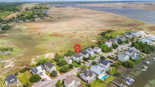 aerial overview of property's location featuring nearby suburban area and a nearby body of water