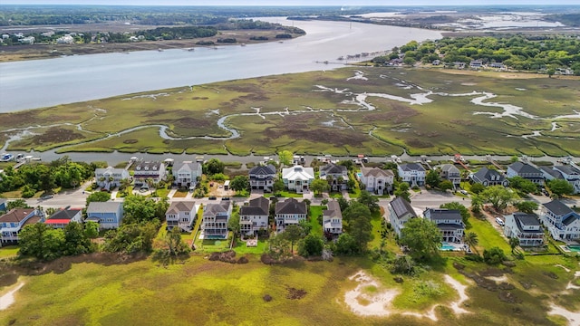 view of property location featuring a nearby body of water and nearby suburban area