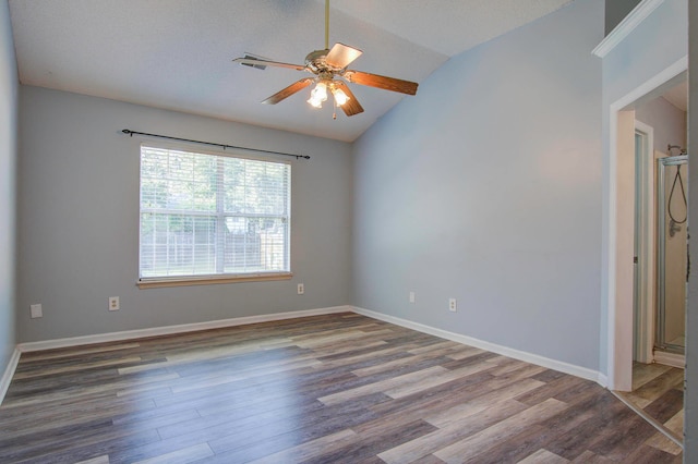 empty room featuring lofted ceiling, ceiling fan, and hardwood / wood-style flooring