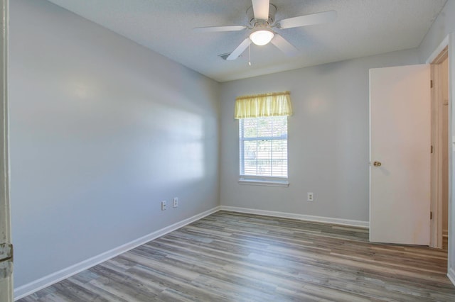 unfurnished room with a textured ceiling, ceiling fan, and hardwood / wood-style floors