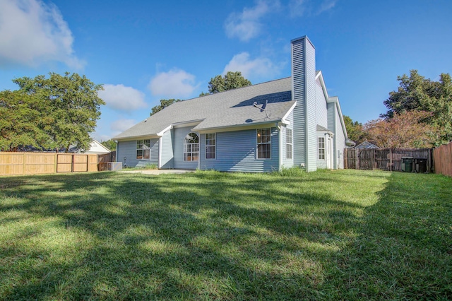 rear view of house featuring a yard