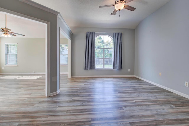 interior space featuring a textured ceiling, ceiling fan, vaulted ceiling, and hardwood / wood-style flooring