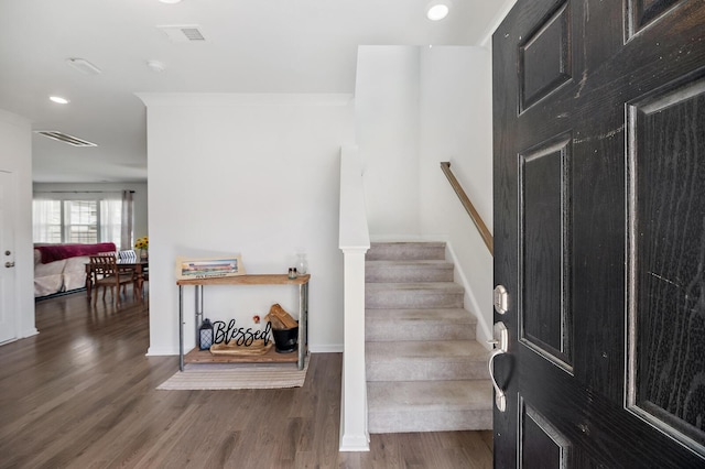 stairs with recessed lighting, visible vents, baseboards, and wood finished floors