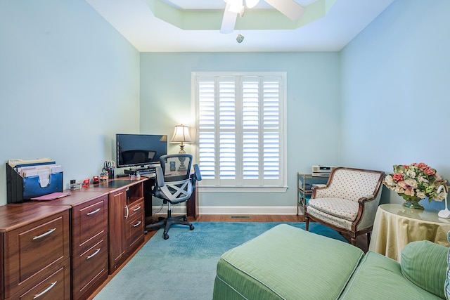 office space featuring ceiling fan, baseboards, a healthy amount of sunlight, and wood finished floors