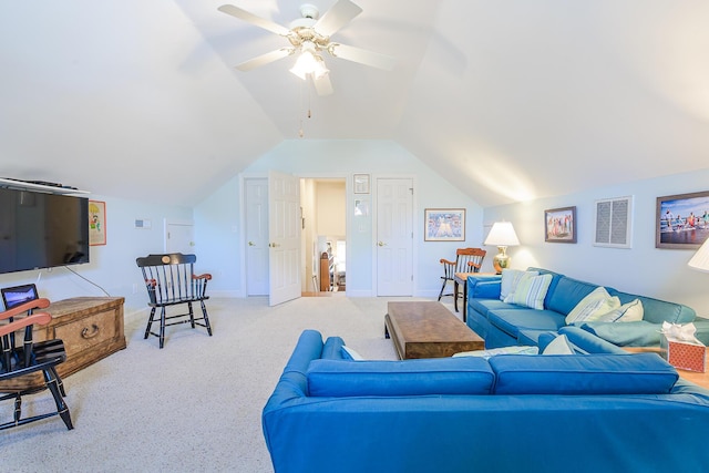 living area featuring baseboards, light colored carpet, ceiling fan, and vaulted ceiling