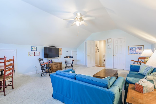 living room with baseboards, lofted ceiling, ceiling fan, and carpet flooring