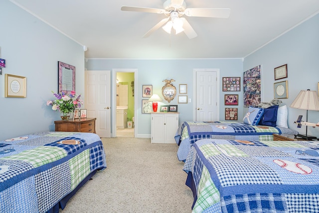 carpeted bedroom featuring ceiling fan, ensuite bathroom, and ornamental molding