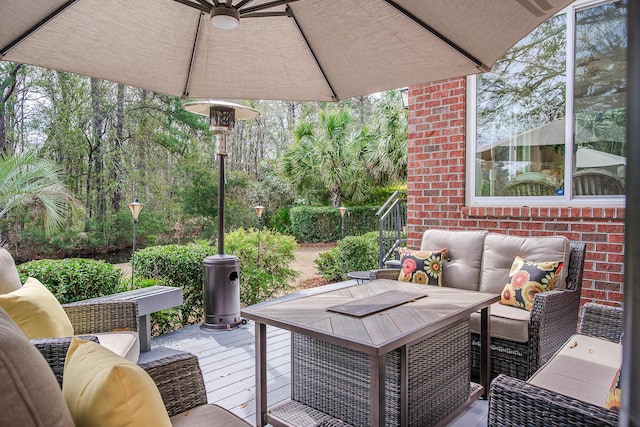 exterior space featuring a wooden deck and outdoor lounge area