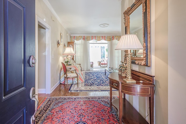 entrance foyer featuring baseboards, wood finished floors, and ornamental molding