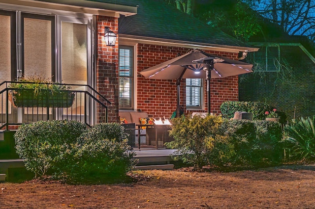 property entrance featuring brick siding