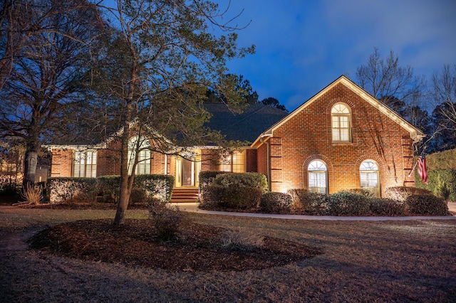 ranch-style house featuring brick siding