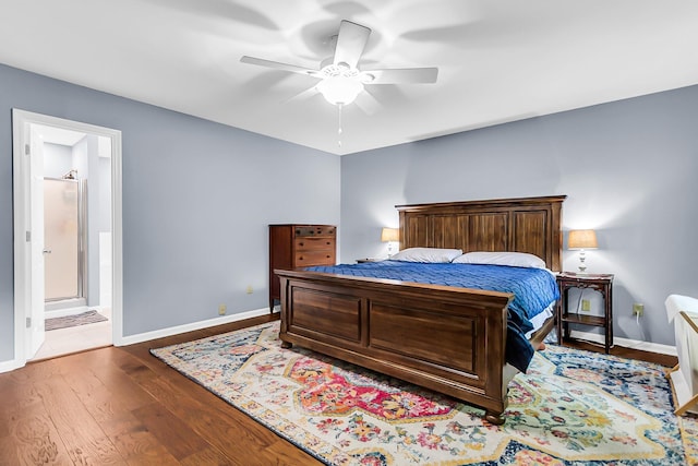bedroom with wood finished floors, ensuite bathroom, baseboards, and ceiling fan