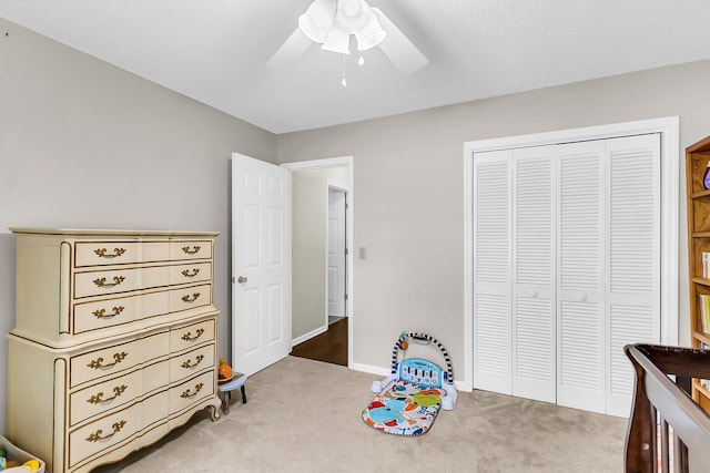bedroom with a ceiling fan, baseboards, a closet, and carpet floors