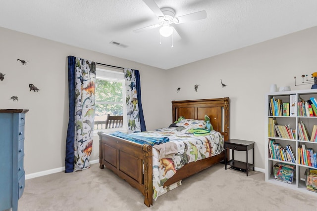 bedroom featuring light colored carpet, visible vents, baseboards, and ceiling fan
