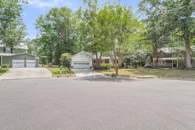 obstructed view of property with driveway and a front yard