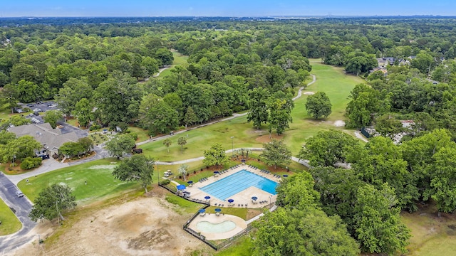 aerial view featuring golf course view and a view of trees