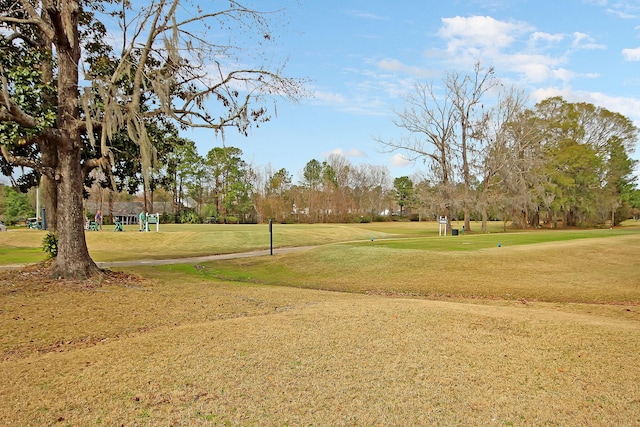 view of home's community featuring a yard and golf course view