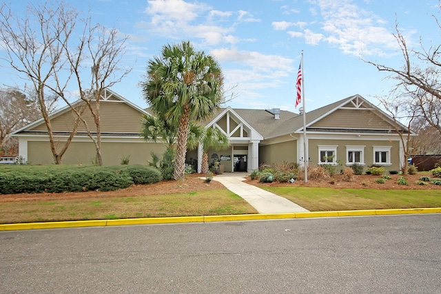 craftsman house with a front yard and stucco siding
