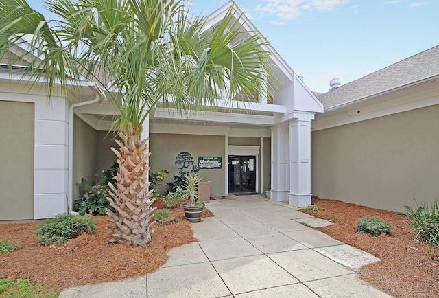 property entrance featuring stucco siding