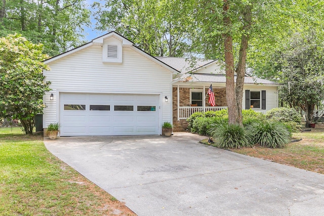 ranch-style home with covered porch, driveway, a garage, and a front lawn