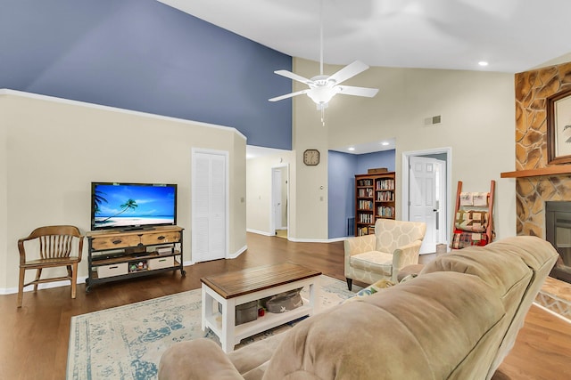 living area featuring high vaulted ceiling, baseboards, a ceiling fan, and wood finished floors