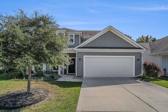 view of front of home with a garage and a front yard