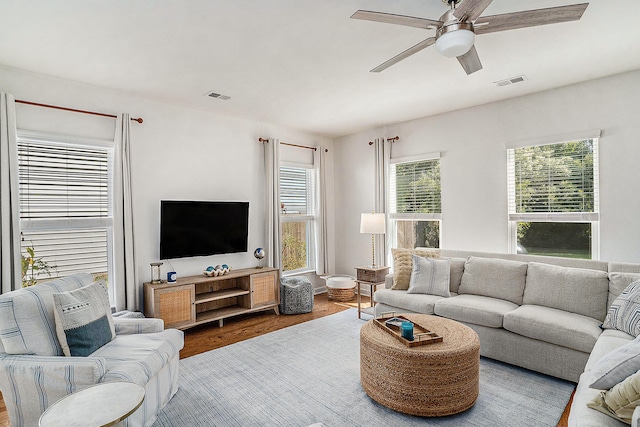 living room featuring ceiling fan and hardwood / wood-style flooring