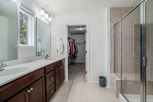 bathroom featuring vanity, a shower with door, and tile patterned floors