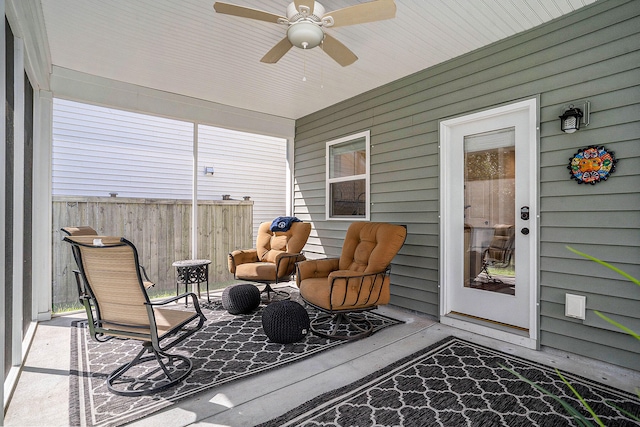 sunroom featuring ceiling fan