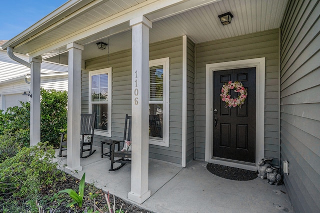 view of exterior entry featuring a porch