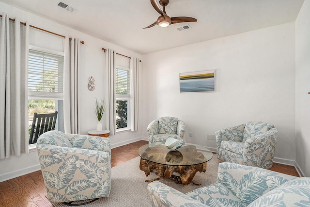 sitting room with hardwood / wood-style flooring and ceiling fan