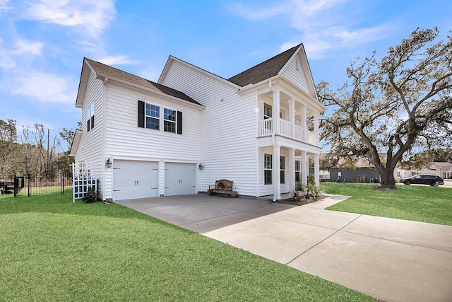 view of home's exterior with a balcony, a garage, fence, a yard, and concrete driveway