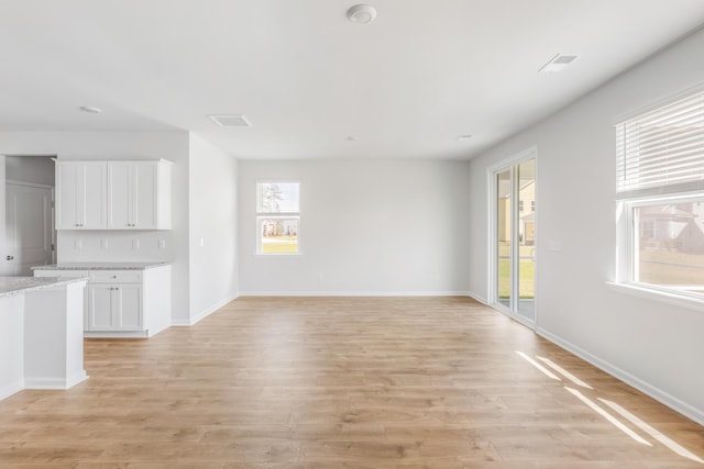 191 E Pinckney St, Summerville, SC 29485 - unfurnished living room with light wood-style flooring and baseboards