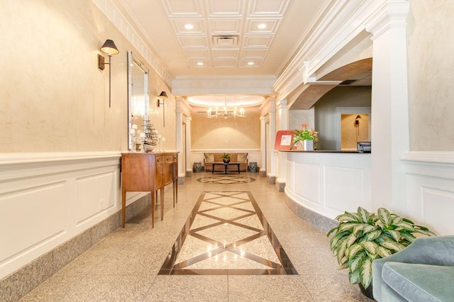 330 Concord St Unit 8E, Charleston, SC 29401 - hallway with a decorative wall, a chandelier, recessed lighting, wainscoting, and an ornate ceiling