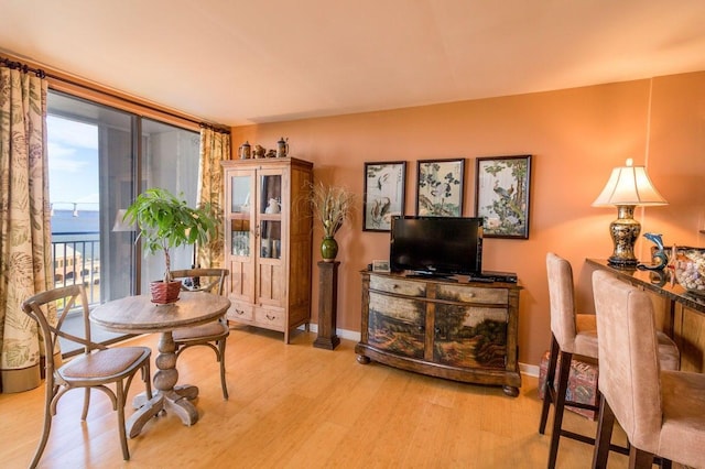 330 Concord St Unit 8E, Charleston, SC 29401 - dining space featuring wood finished floors and baseboards