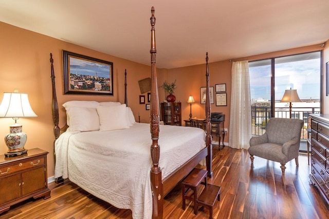 330 Concord St Unit 8E, Charleston, SC 29401 - bedroom with access to exterior, dark wood finished floors, and baseboards
