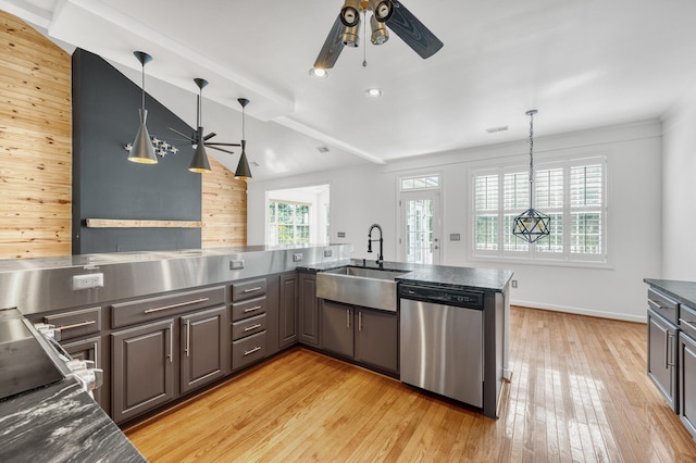 kitchen with kitchen peninsula, dishwasher, sink, and decorative light fixtures