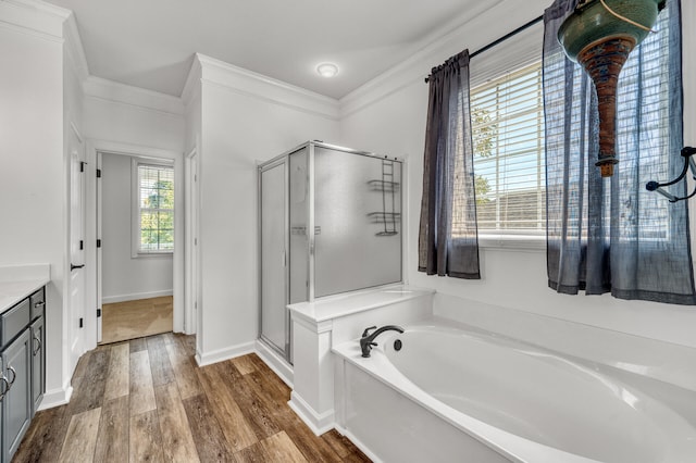 bathroom featuring wood-type flooring, vanity, separate shower and tub, and ornamental molding