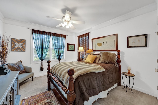 carpeted bedroom with ornamental molding and ceiling fan