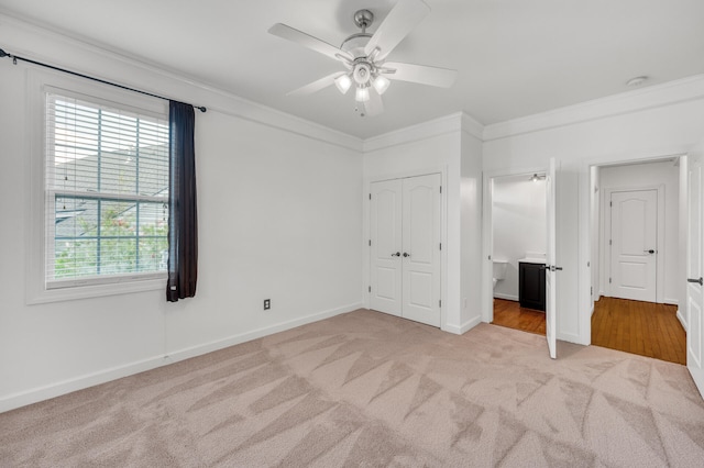 unfurnished bedroom with ceiling fan, light colored carpet, ornamental molding, and multiple windows