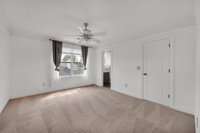 carpeted empty room featuring crown molding and ceiling fan