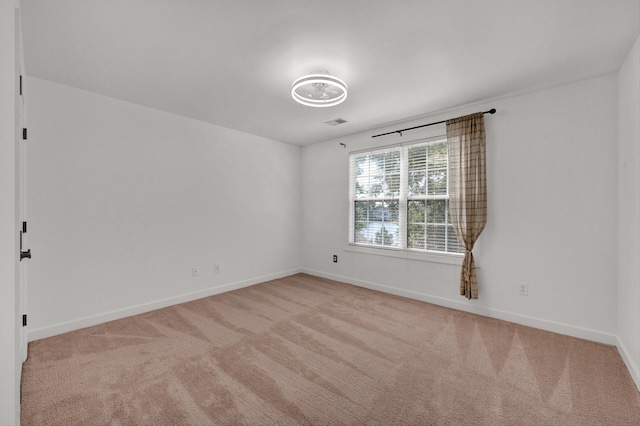 spare room with light colored carpet