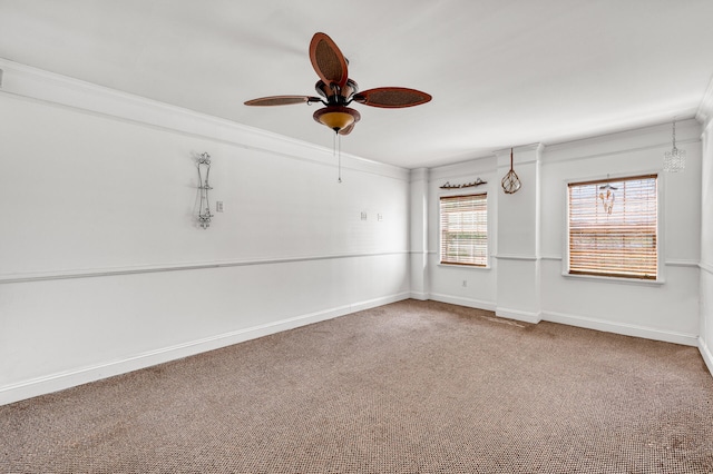 carpeted empty room with ceiling fan and crown molding