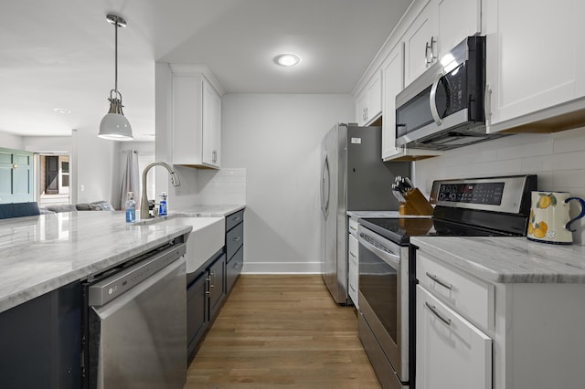 1445 Downwood Pl, Charleston, SC 29412 - kitchen featuring appliances with stainless steel finishes, a sink, white cabinetry, backsplash, and recessed lighting