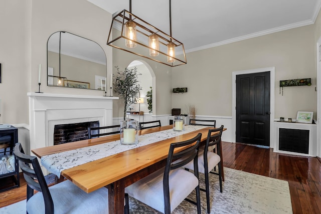 dining space with hardwood / wood-style floors and crown molding