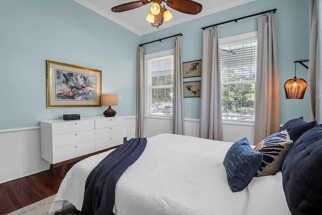 bedroom featuring ceiling fan, wood-type flooring, and crown molding