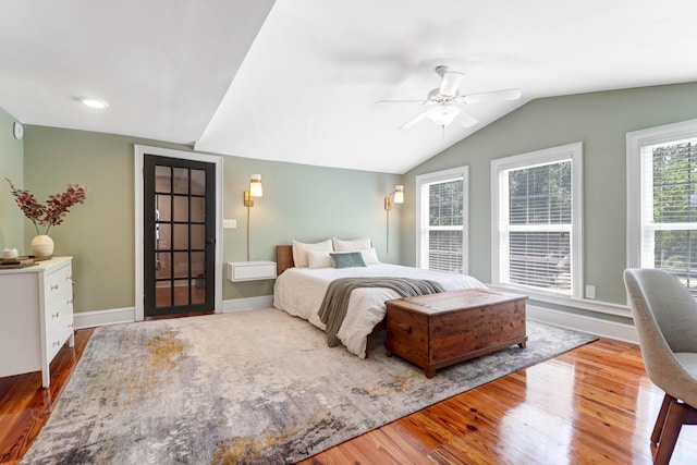 bedroom featuring ceiling fan, wood-type flooring, and vaulted ceiling