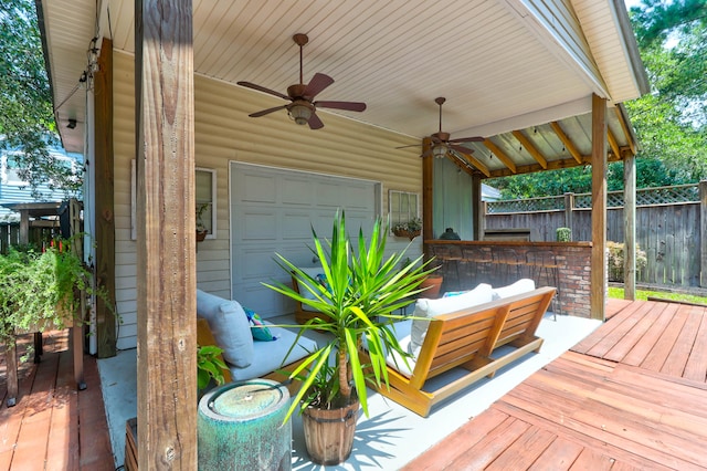 wooden terrace featuring ceiling fan and an outdoor living space